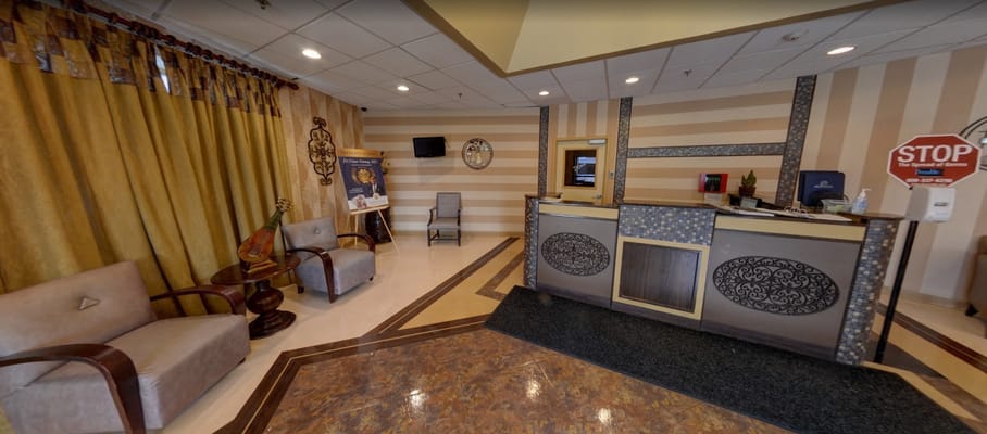 Lobby area with seating and reception desk at Oakwood Residence