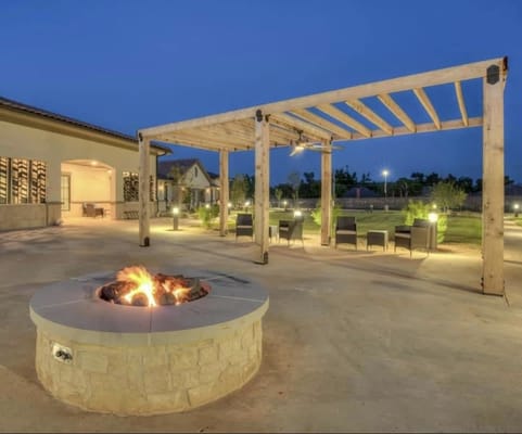 Outdoor seating area with fire pit and pergola