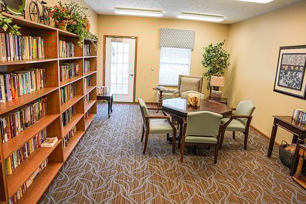 Cozy library area with bookshelves and seating