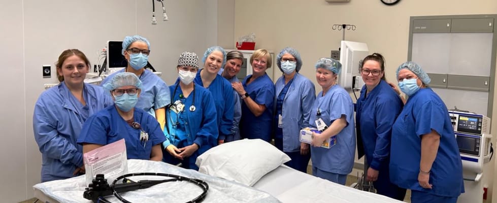 Nursing staff posing together in a medical room