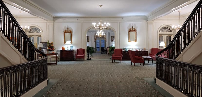 Elegant lobby area with grand staircase and seating