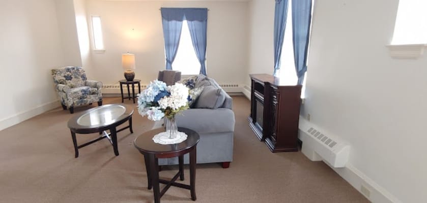 Cozy living area with floral chairs and a decorative table