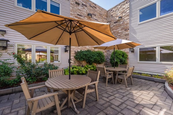 Outdoor seating area with umbrellas and greenery