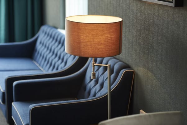 Cozy lounge area with blue sofas and lamp