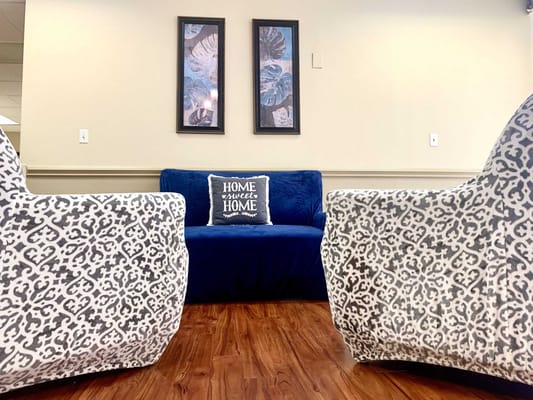 Cozy common area with decorative chairs and a sofa
