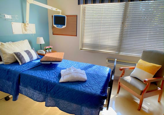 Cozy resident room with bed and chair