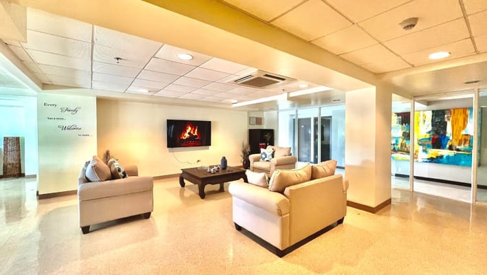 Spacious living room with modern furniture and artwork.