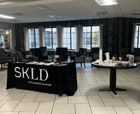 Table with informational materials and refreshments in the lobby area of SKLD Leonard.