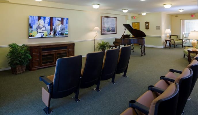 Lounge area featuring seating, a piano, and a television.