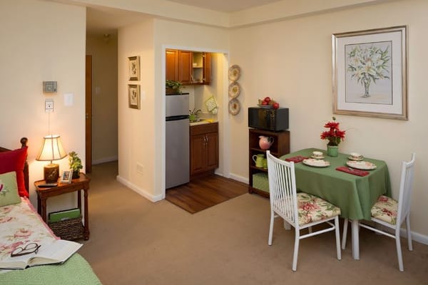 Interior view of a cozy apartment with dining area and kitchenette