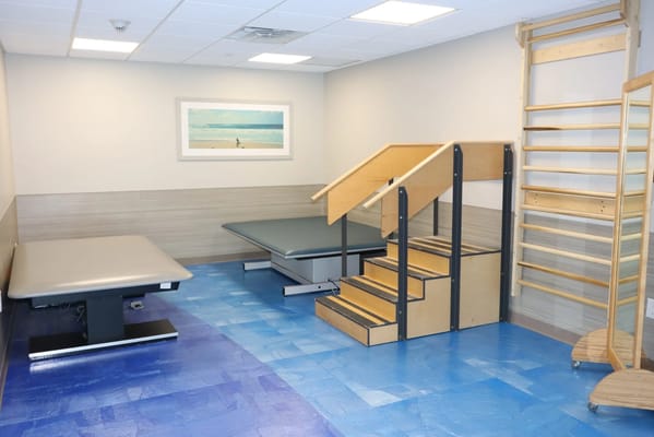 A therapy room with steps and exercise equipment