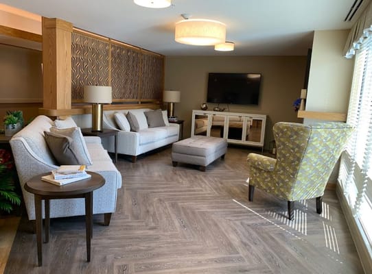 A shared living room with comfortable seating and natural light