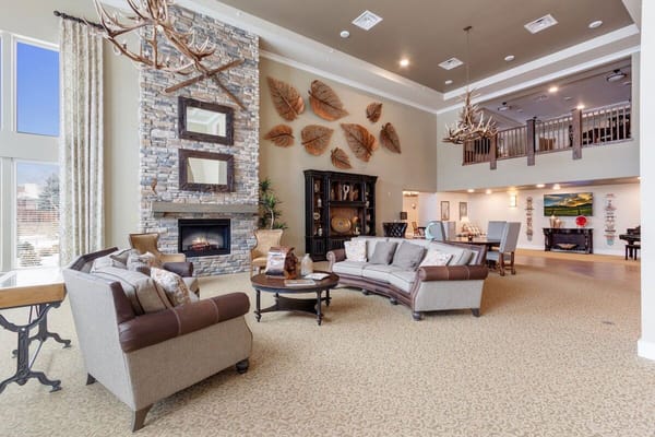 Inviting lobby area with comfortable seating and a stone fireplace.