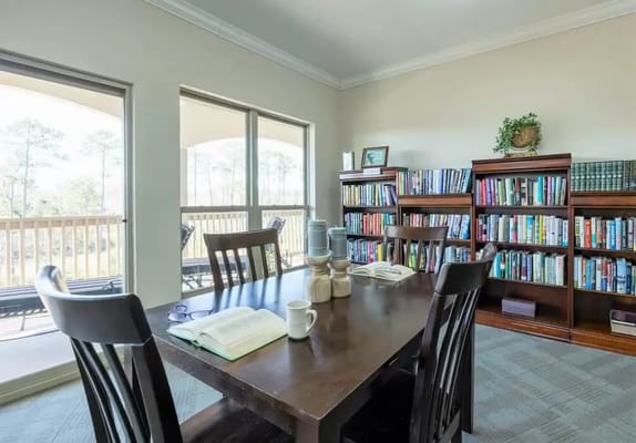 Bright common area with bookshelves and a table