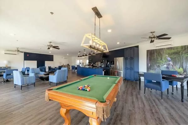 Interior of a common area with a pool table and seating