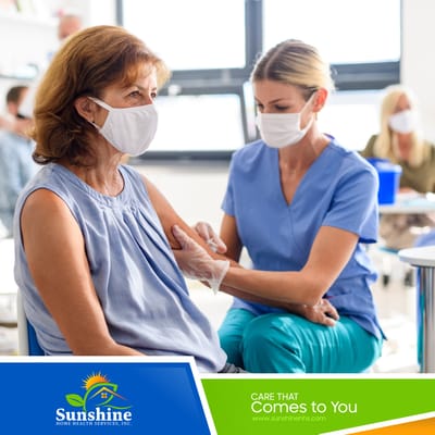Healthcare professional administering a vaccine to a senior resident