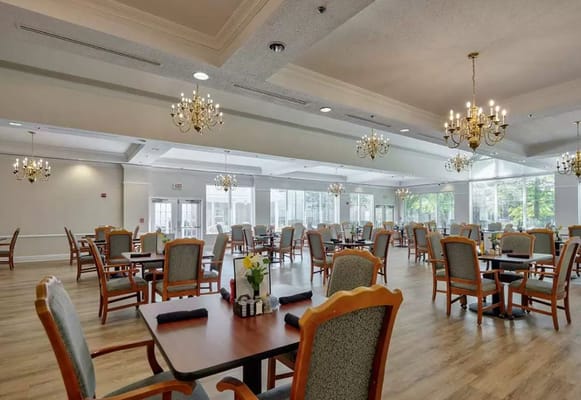 Bright and spacious dining room with tables and chairs