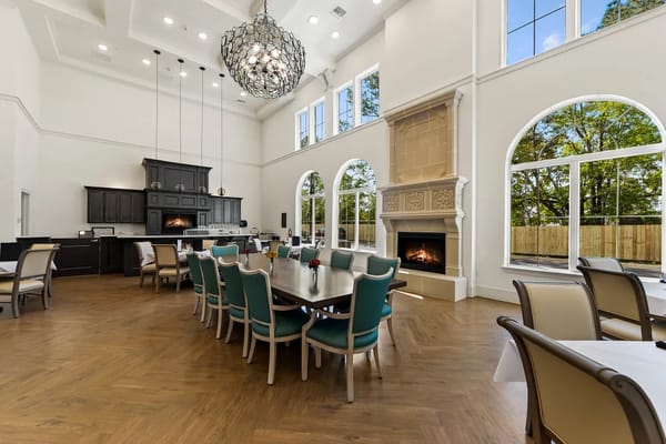 Spacious dining room with a fireplace and large windows