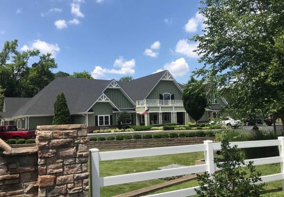 Front view of The Courtyards senior living facility with greenery and blue sky