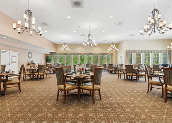 Dining area with tables and chairs in warm lighting