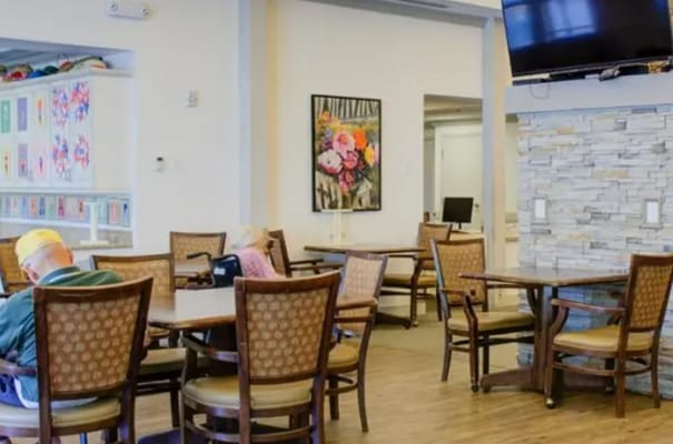 Residents enjoying time in a common area with floral decor