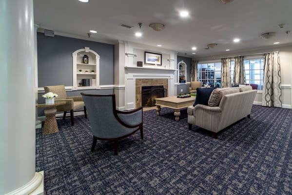 A cozy common area with seating and a fireplace