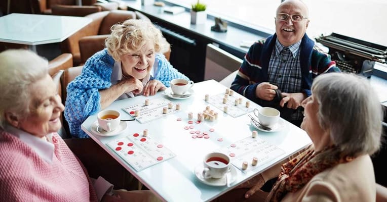 Residents enjoying a bingo game with drinks