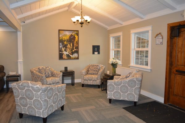 Cozy seating area with patterned chairs and artwork