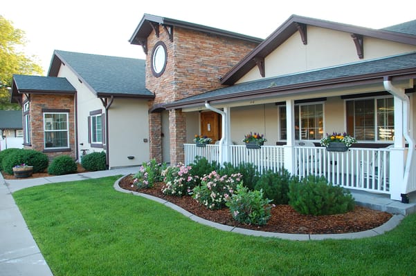 Front exterior of a senior living facility with garden