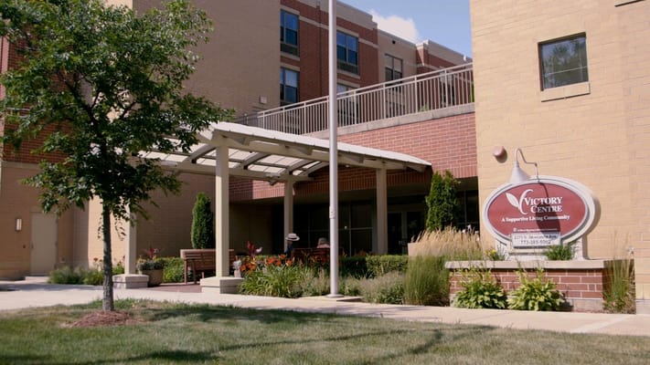 Front entrance of Victory Centre with landscaping and canopy.