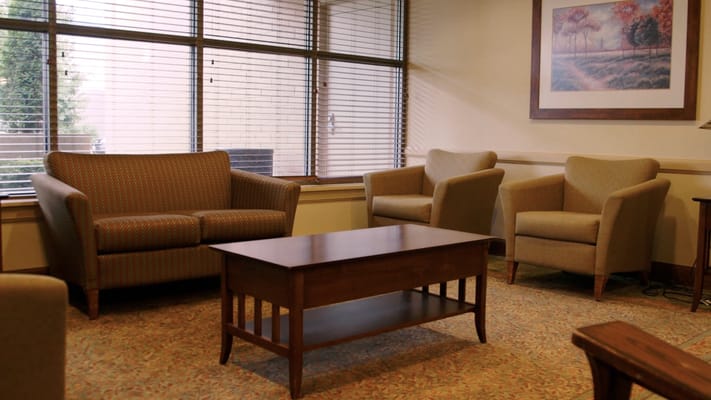 Cozy lounge area with a sofa, two chairs, and a coffee table.