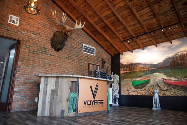 Stylish reception area featuring a moose head and scenic mural