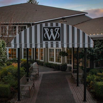 Entrance awning at Weatherly Inn Tacoma with striped canopy