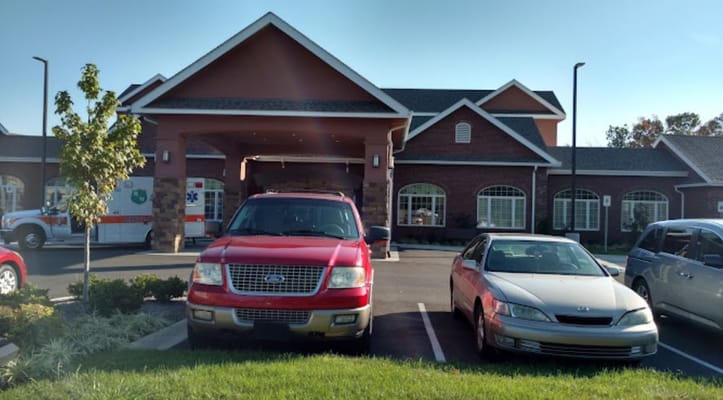 View of the entrance of Shannondale Well Park with parked cars.