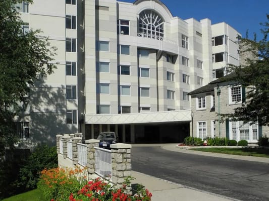 Entrance of Wesley Glen senior living facility with a modern building and landscaped entryway.