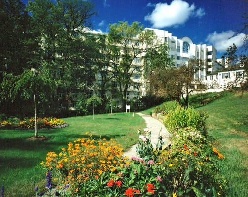 Flower-filled garden in front of Wesley Glen senior living facility.