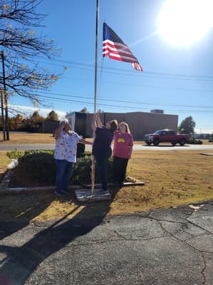 Residents raising a flag outside the facility