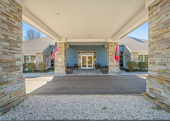 Welcoming entrance to Windsor Ridge Assisted Living with flags.