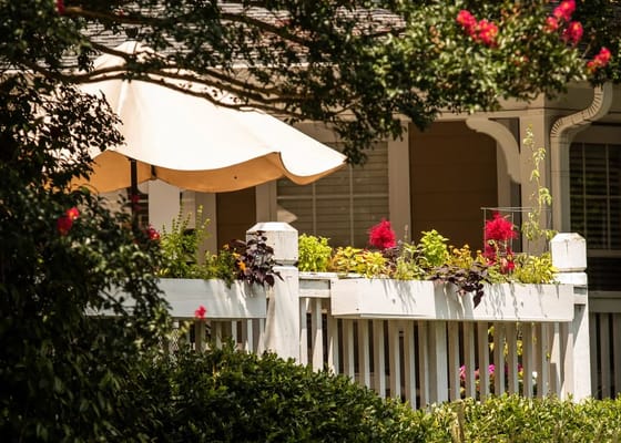 Flower beds and an umbrella at a retirement community