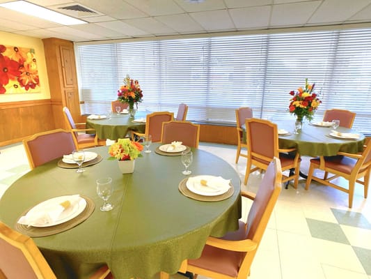 Dining room setup with flower arrangements and table settings