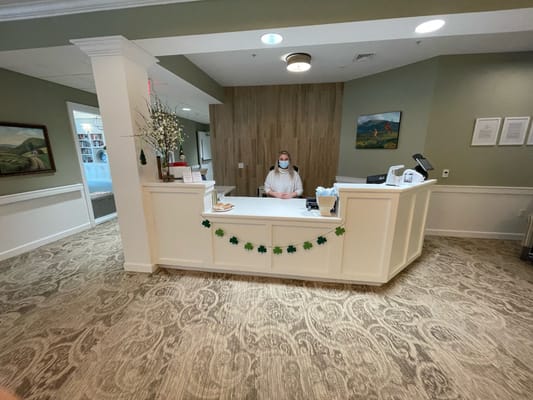 Reception desk with staff member wearing a mask at Bowman Place