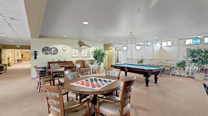 Cozy leisure area with tables, a pool table, and seating.