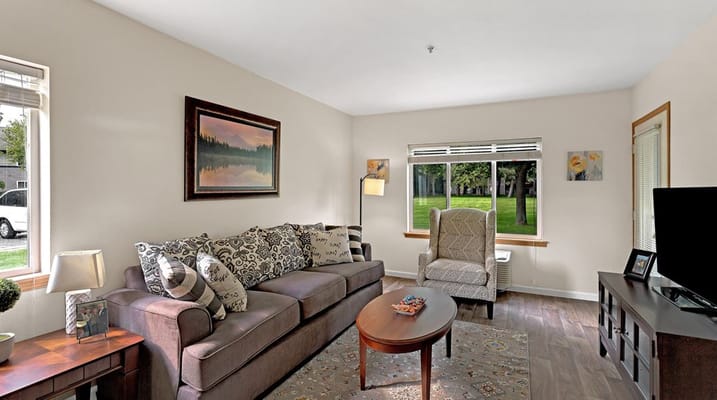 Spacious living room with comfortable seating and large window