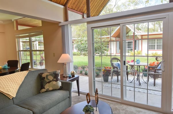 Cozy living room with patio view and garden.