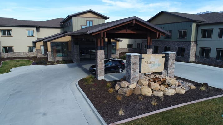 Entrance of Maple Springs facility with stone signage and landscaping