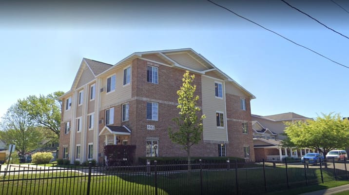 A tranquil garden with a gazebo and pond at Roseville Commons Senior Living.