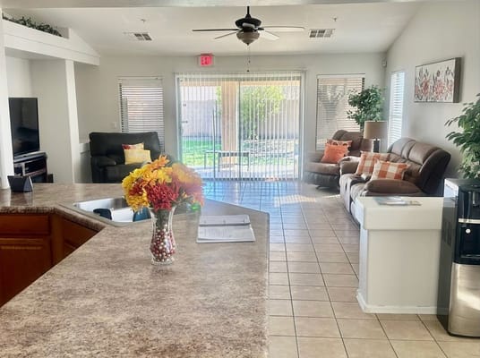 Cozy living room with seating area and a view of the backyard