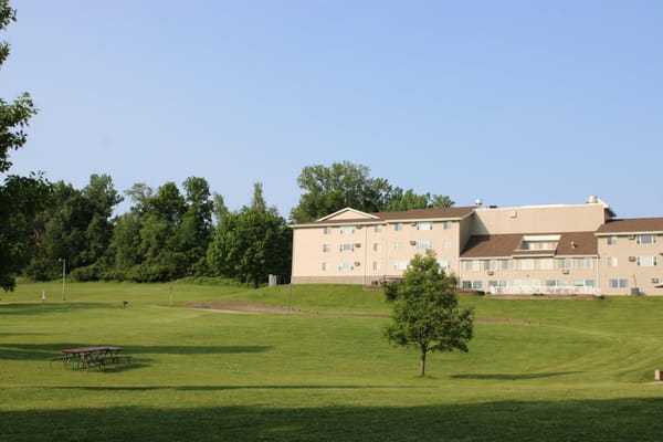 View of Trailside Gardens senior living facility surrounded by greenery