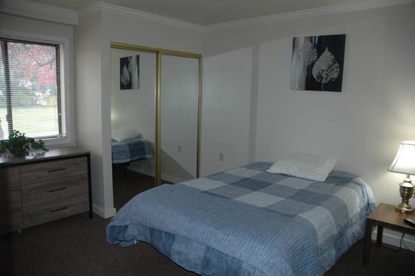 Private resident room with a bed and dresser