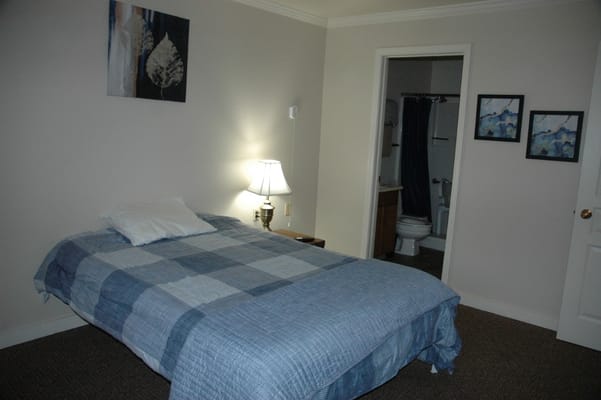 Cozy private room with a bed and artwork